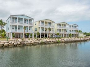 Marathon apartment for rent - A row of beach houses are situated on a waterfront.