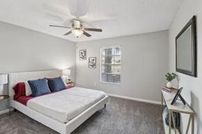 Daytona Beach apartment for rent - A bedroom with a large bed and a ceiling fan.