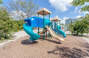 Key Largo townhouse for rent - A playground with a blue slide and a yellow top.