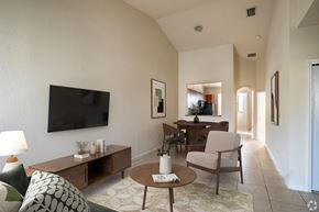 Homestead townhouse for rent - A living room with a flat screen TV mounted on the wall.