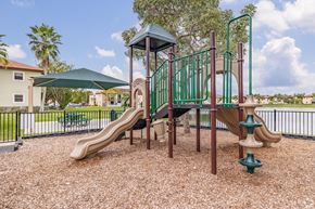 Homestead apartment for rent - A playground with a green slide and a brown slide.