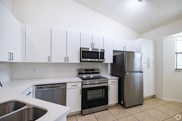 Homestead apartment for rent - A kitchen with white cabinets and stainless steel appliances.
