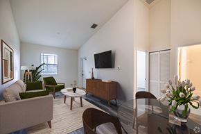 Homestead apartment for rent - A living room with a couch, chairs, a coffee table, and a television.