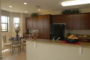 Homestead townhouse for rent - a kitchen with a bar and a table with chairs