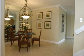Homestead townhouse for rent - a dining room with a table and chairs and a chandelier