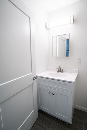 Marathon apartment for rent - A white bathroom with a sink and a mirror.
