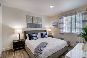 Cerritos apartment for rent - Bright bedroom with a large bed and a window letting in natural light.
