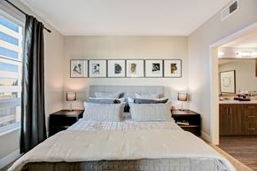 Orange apartment for rent - Bedroom with bed and framed pictures at Eleven 10 in Orange, CA