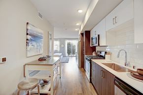 Orange apartment for rent - Modern kitchen featuring a sleek countertop, undermount sink, and high-end finishes at Eleven10