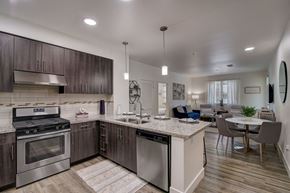 Cerritos apartment for rent - Modern open kitchen with stainless steel appliances, a marble countertop, and sleek cabinetry.