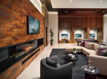 Laguna Niguel apartment for rent - A modern living room with a fireplace and a large painting on the wall.