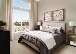 Laguna Niguel apartment for rent - A bedroom with a large bed and a view of the city through the window.