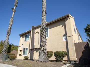 San Diego apartment for rent - a building with two palm trees in front of it