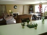 Tacoma apartment for rent - A living room with a couch, chair, and table.