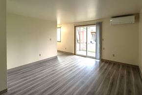 Lakewood apartment for rent - A room with a wooden floor and sliding glass doors.