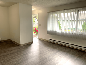 Tacoma apartment for rent - A room with wooden floors and a window with blinds.