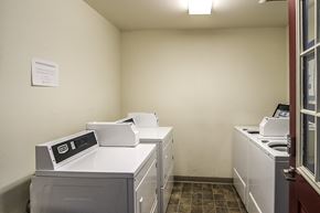 Lakewood apartment for rent - A white wall with a paper on it and a washing machine.