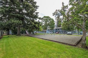 Lakewood apartment for rent - A playground with a swing set and a slide in the background.