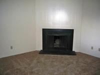 Lakewood apartment for rent - A black fireplace in a room with a brown carpet.