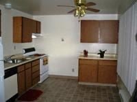 Lakewood apartment for rent - A kitchen with wooden cabinets and a fan.