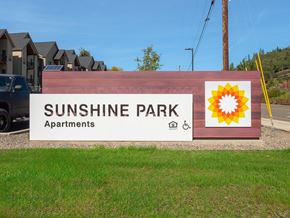 Roseburg apartment for rent - a sign for sunshine park apartments with a sunflower on it