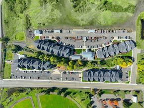 Roseburg apartment for rent - a birds eye view of a parking lot with cars and buildings