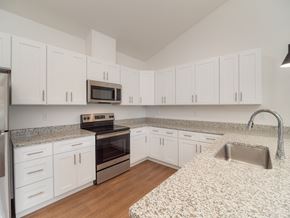 Roseburg apartment for rent - a kitchen with granite counter tops and white cabinets
