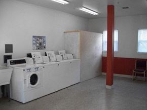 Portland apartment for rent - an empty laundry room with washing machines and a red pole
