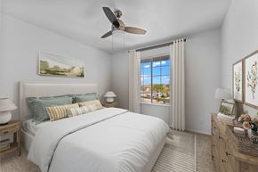 Wickenburg apartment for rent - A bedroom with a large bed and a ceiling fan.