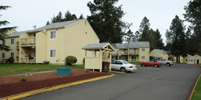 Sutherlin apartment for rent - a parking lot with cars in front of apartment buildings