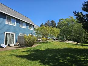 Lincoln City apartment for rent - A blue house with a green lawn in front.