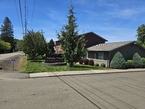Roseburg apartment for rent - A sign in front of a house reads "Parkside Villas".