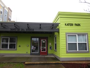 Portland apartment for rent - the building is painted yellow and green and has a red door