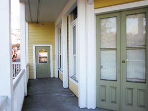 Portland apartment for rent - the front porch of a yellow house with a green door