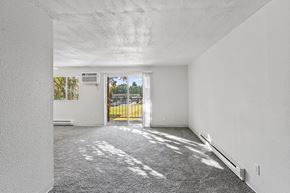 Medford apartment for rent - the living room of an empty apartment with a door to the balcony