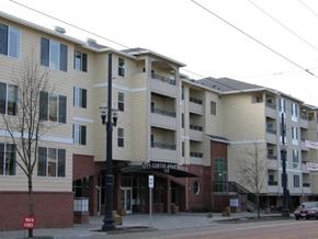 Hillsboro apartment for rent - A multi-story apartment building with a red sign in front.