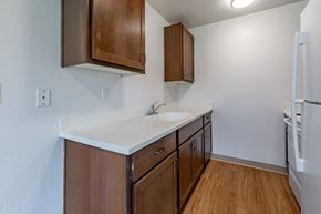 Chehalis apartment for rent - A kitchen with wooden cabinets and a white countertop.