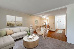 Bremerton apartment for rent - A living room with a grey couch, a white coffee table, and a grey rug.