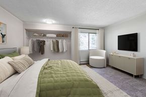 Bremerton apartment for rent - A bedroom with a large bed and a green comforter.