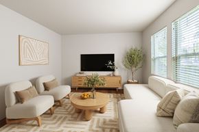 Port Townsend apartment for rent - A living room with a white couch, a wooden coffee table, and a flat screen TV.