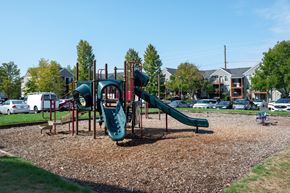 Portland apartment for rent - A playground with a green slide and a red and green play structure.