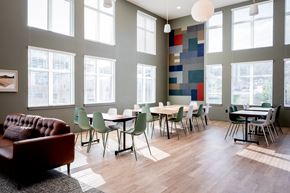 Portland apartment for rent - a dining room with tables and chairs and large windows