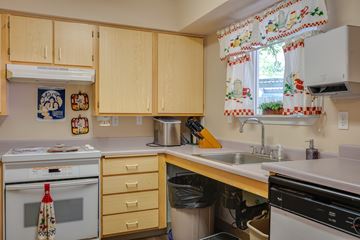 Beaverton apartment for rent - A kitchen with wooden cabinets and a white oven.