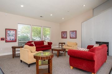 Hillsboro apartment for rent - A living room with a red couch and a fireplace.