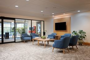 Portland apartment for rent - A conference room with blue chairs and a wooden table.