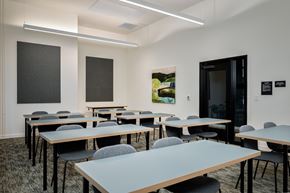 Portland apartment for rent - a classroom with tables and chairs and a door