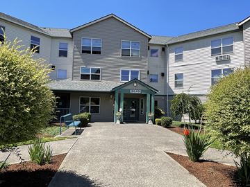 Beaverton apartment for rent - The front of a building with a green awning and a sign that reads "1240" is shown.