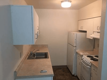 Portland apartment for rent - a kitchen with a sink and a stove and a refrigerator