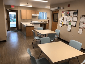 Portland apartment for rent - a multipurpose room with tables and chairs and a kitchen
