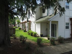 Canby apartment for rent - a row of white houses with a lawn and trees